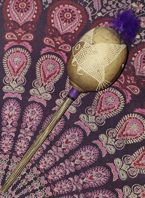 Shamanic rattle on a patterned cloth